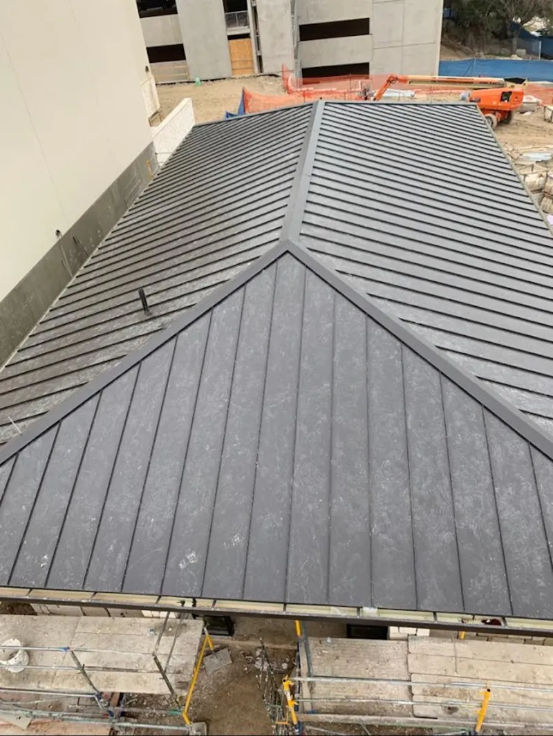 Commercial metal roof construction with crane equipment in Vandalia